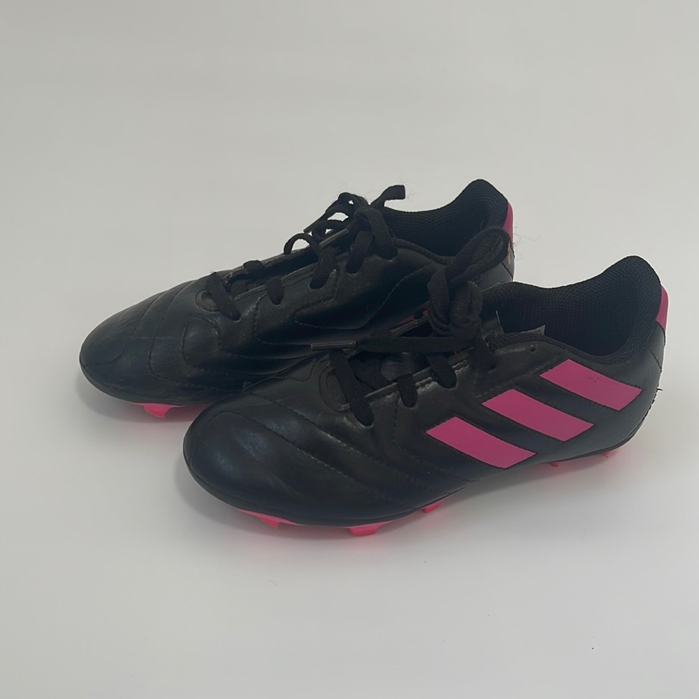 Size 1 Adidas girls soccer cleats. Excellent!Include 1 pair of shin guards.